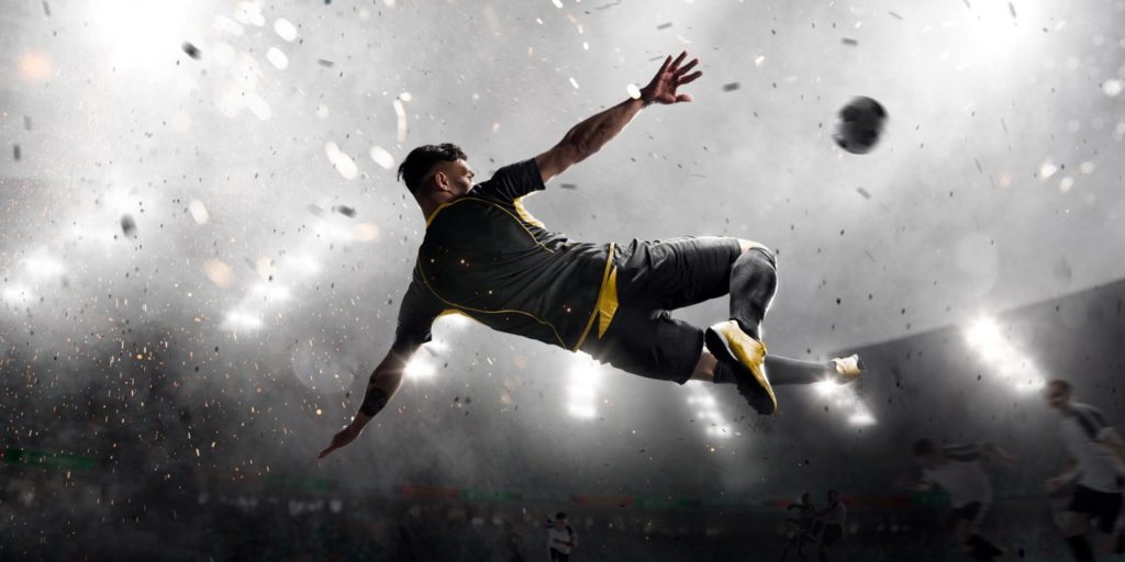 Man jumping to kick soccer ball